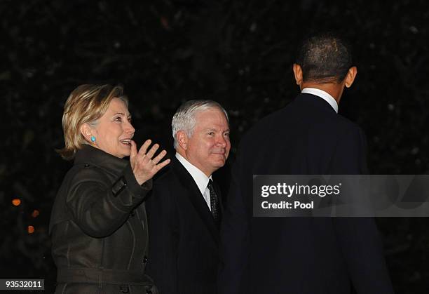 President Barack Obama , Secretary of State Hillary Clinton and Defense Secretary Robert Gates walk across the South Lawn of the White House to board...