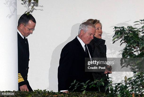 Chairman of the Joint Chiefs of Staff Admiral Michael Mullen, Defense Secretary Robert Gates and Secretary of State Hillary Clinton walk from the...