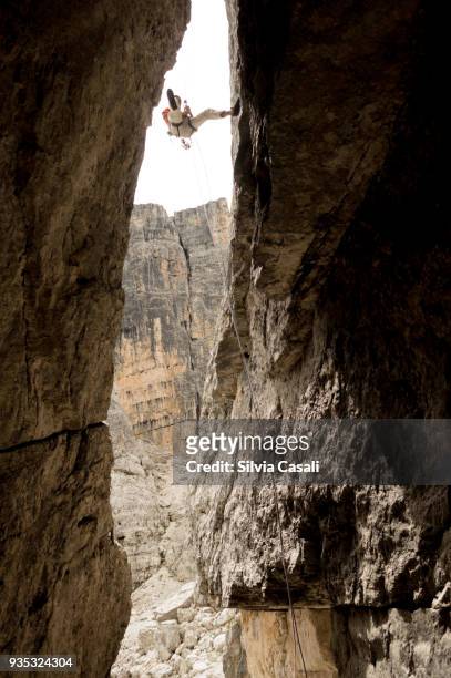 climbing down on the dolomites - silvia casali stock pictures, royalty-free photos & images