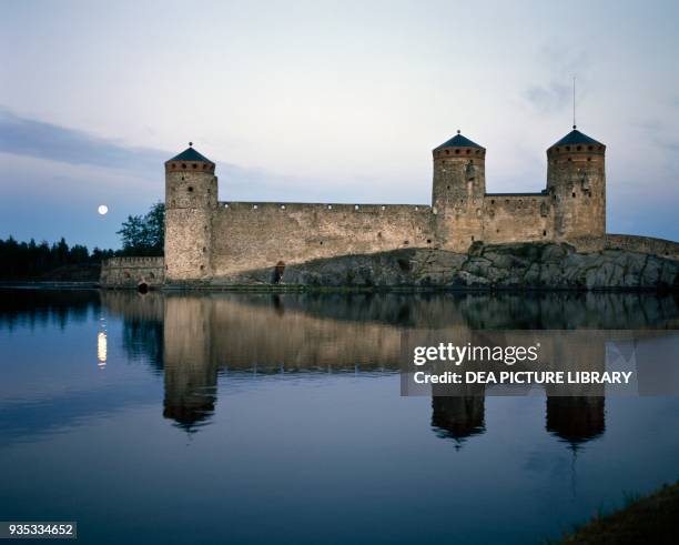 View of Olavinlinna castle at dusk Savonlinna, Finland, 15th century.