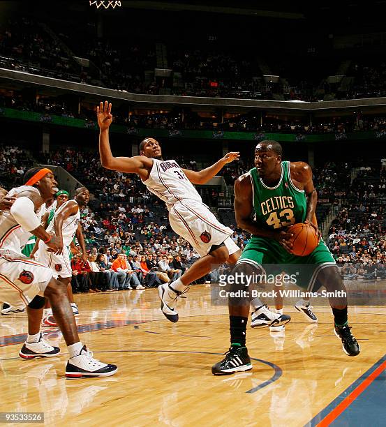 Kendrick Perkins of the Boston Celtics drives to the basket against Boris Diaw of the Charlotte Bobcats on December 1, 2009 at the Time Warner Cable...