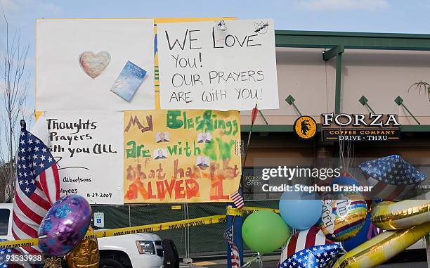 Messages and balloons from well wishers sit outside the Forza Coffee Company store December 1, 2009 near Lakewood, Washington. The company has...