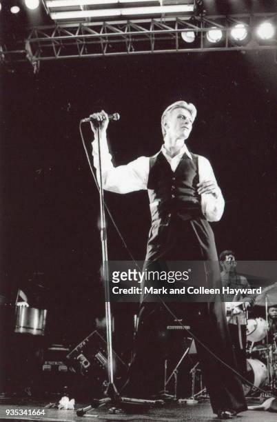 David Bowie performs on stage on the Isolar tour at Ahoy, Rotterdam, Netherlands, May 1976. Guitarist Carlos Alomar and drummer Dennis Davis are...
