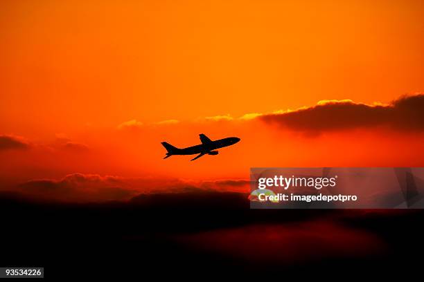 flying airplane over sunset - red plane stock pictures, royalty-free photos & images