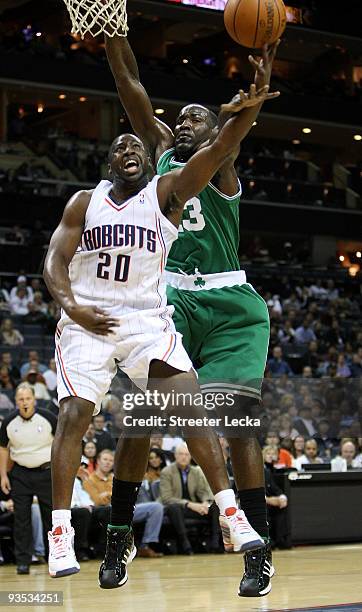 Kendrick Perkins of the Boston Celtics fouls Raymond Felton of the Charlotte Bobcats during their game at Time Warner Cable Arena on December 1, 2009...