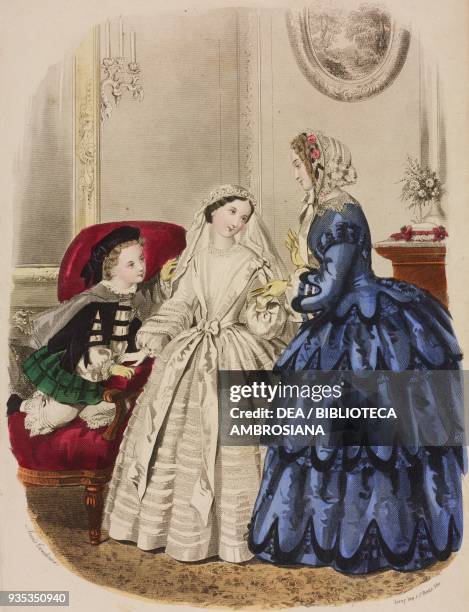 Boy wearing a XVII century Sottish-style outfit, girl wearing a first communion dress, woman wearing a blue silk and poplin dress with velvet...