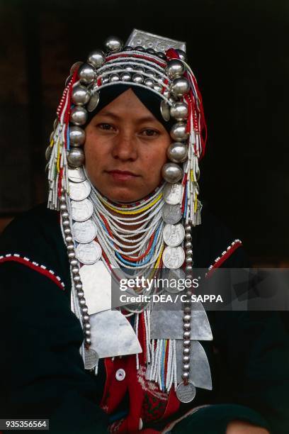 Akha woman wearing a headdress and traditional ornaments, Thailand.