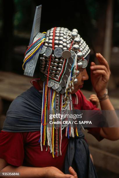 Akha woman wearing a traditional headdress, Thailand.