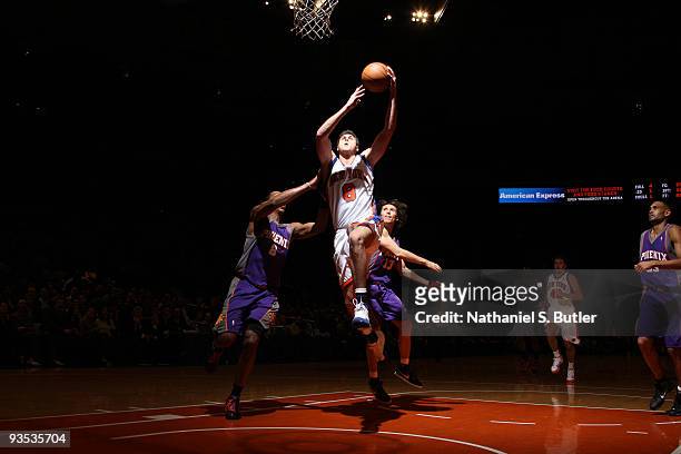 Danilo Gallinari of the New York Knicks shoots against Channing Frye and Steve Nash of the Phoenix Suns on December 1, 2009 at Madison Square Garden...