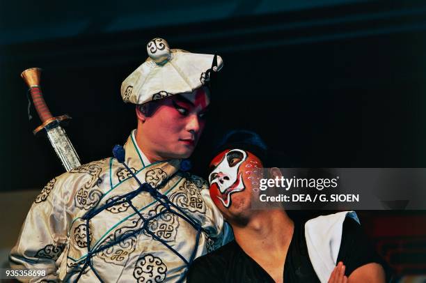 Actors with their faces painted with typical stage make-up, Chinese opera in Taipei, Taiwan.