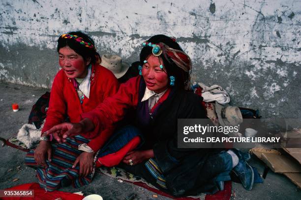 Khampas nomadic women with typical hairstyles to Barkhor Market, Tibet, China.