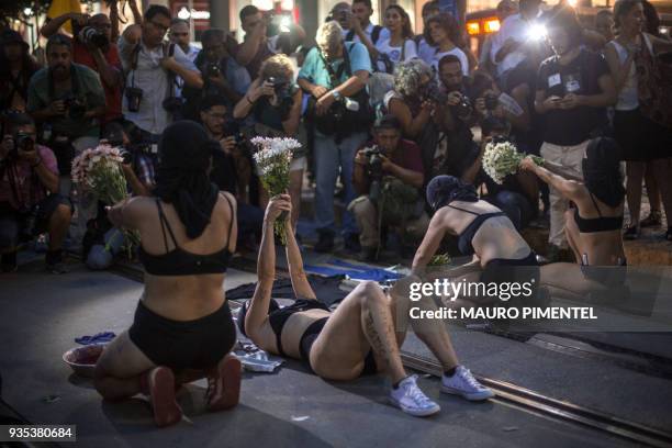 Protesters take part in a demonstration against the murder of Brazilian councilwoman and activist Marielle Franco in front of Rio's Municipal...