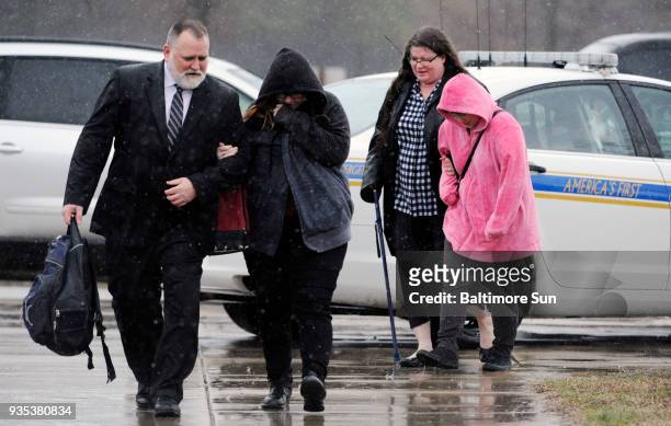 From left, Brian Morgan walks arm-in-arm with his daughter, Bethanie Morgan, as his wife, Susan Morgan, and daughter, Brittanie Morgan, follow, on...