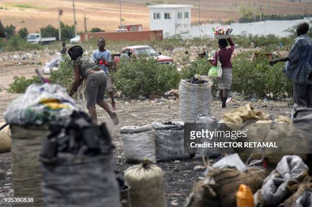 Charcoal sellers wait for customers at the Titanyen Market outside of Port-au-Prince, Haiti on March 20, 2018. This market is filled with sellers and...