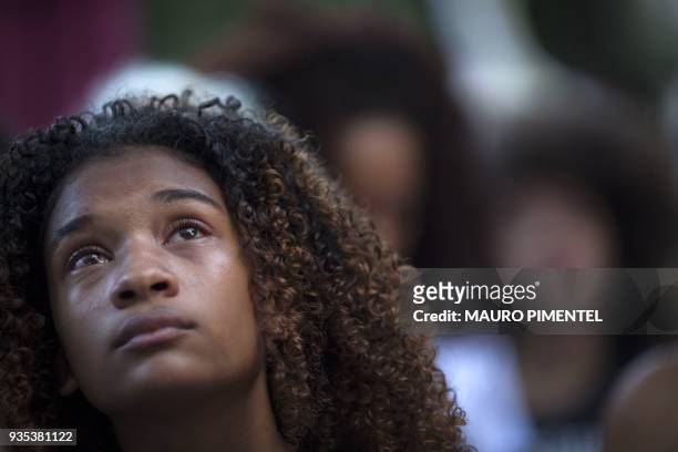 Protester crying in a demonstration against the murder of Brazilian councilwoman and activist Marielle Franco in front of Rio's Municipal Chamber,...