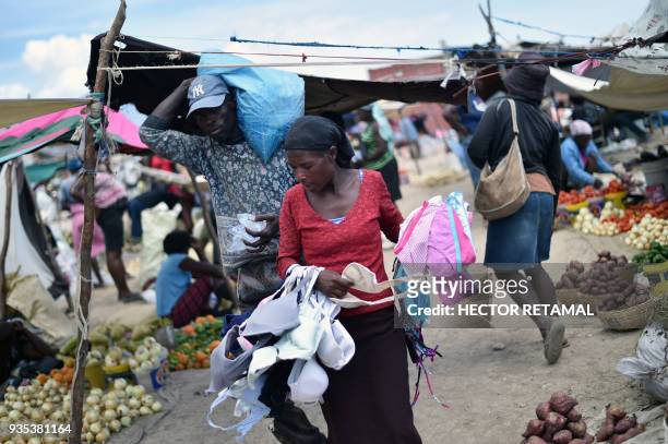 An underwear sales woman carries her goods at the Titanyen Market outside of Port-au-Prince, Haiti on March 20, 2018. This market is filled with...