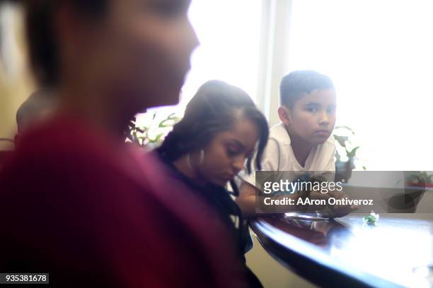 Isaac Flores listens as his mother Evette Flores-Prieto talks about her late husband Roberto Andres Flores-Prieto on Tuesday, March 20, 2018. The...