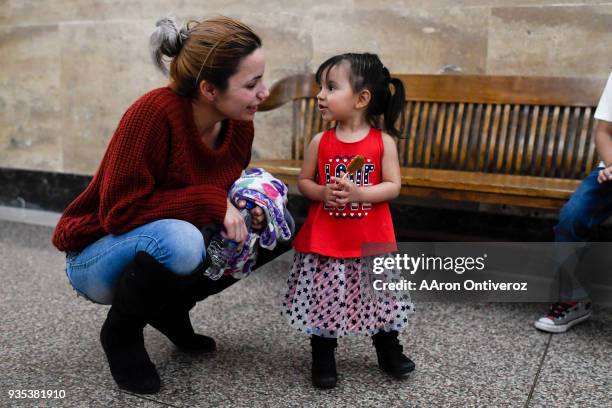 Evette Flores-Prieto talks to her daughter Mikaela after she spoke about her late husband Roberto Andres Flores-Prieto at mayor Michael B. Hancock's...