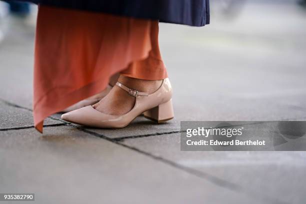 Guest wears salmon colored shoes, during London Fashion Week February 2018 on February 16, 2018 in London, England.