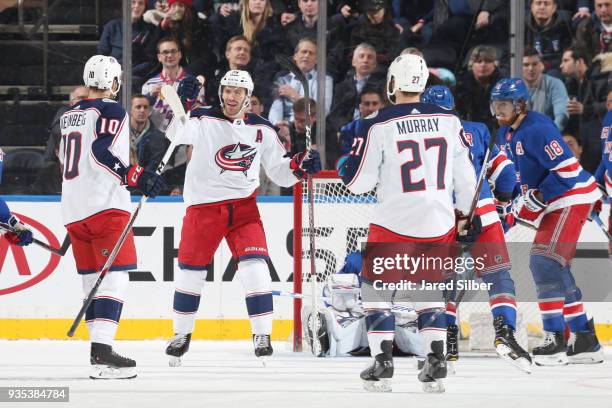 Alexander Wennberg, Boone Jenner and Ryan Murray of the Columbus Blue Jackets celebrate after scoring a goal in the first period against Henrik...