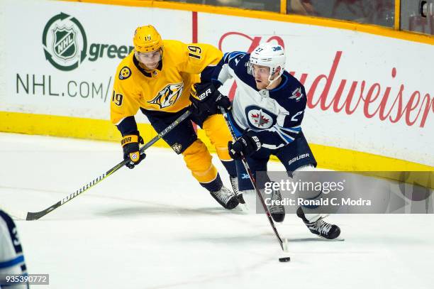 Nikolaj Ehlers of the Winnipeg Jets skates against Calle Jarnkrok of the Nashville Predators during an NHL game at Bridgestone Arena on March 13,...