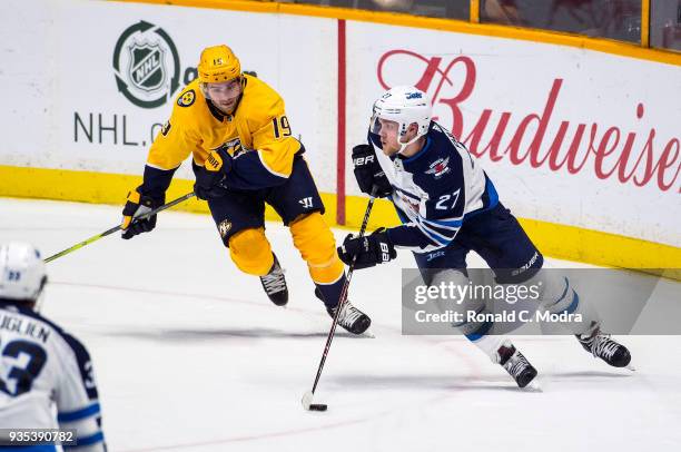 Nikolaj Ehlers of the Winnipeg Jets skates against Calle Jarnkrok of the Nashville Predators during an NHL game at Bridgestone Arena on March 13,...