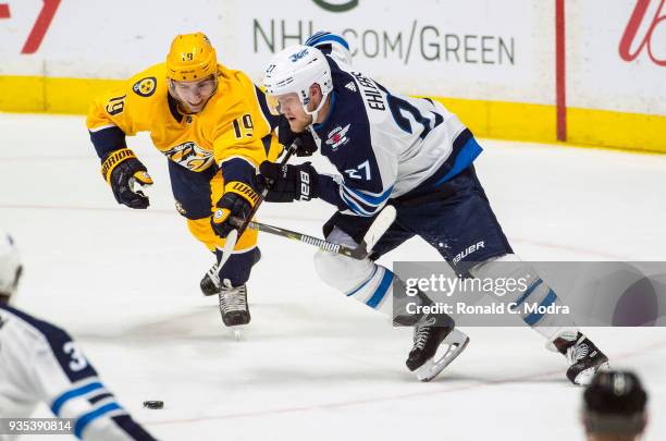 Nikolaj Ehlers of the Winnipeg Jets skates against Calle Jarnkrok of the Nashville Predators during an NHL game at Bridgestone Arena on March 13,...