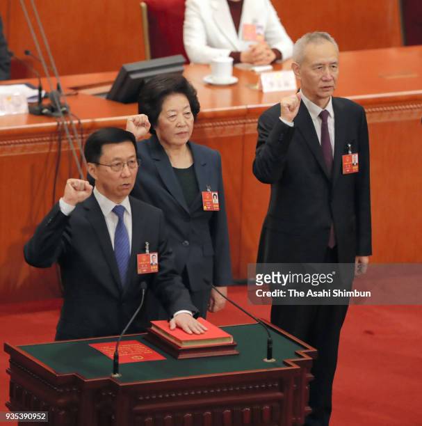 Newly elected Vice Premiers Han Zheng, Sun Chunlan and Liu He swear an oath during the seventh plenary session of the 13th National People's Congress...