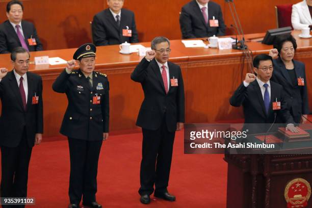 Vice Premier Hu Chunhua swears an oath during the seventh plenary session of the 13th National People's Congress at the Great Hall of the People on...