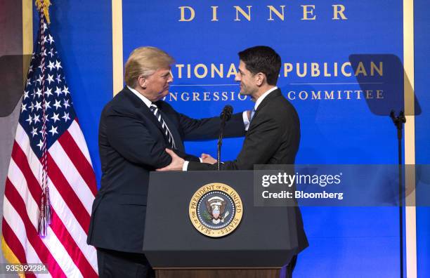 President Donald Trump, left, shakes hands with U.S. House Speaker Paul Ryan, a Republican from Wisconsin, before delivering a speech at the National...