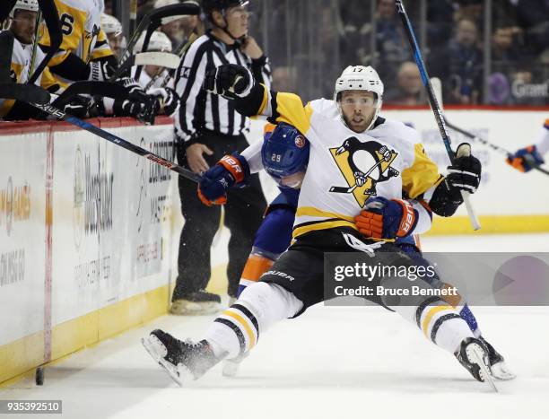 Brock Nelson of the New York Islanders gets under Bryan Rust of the Pittsburgh Penguins during the second period at the Barclays Center on March 20,...