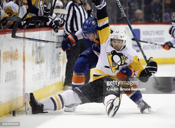 Brock Nelson of the New York Islanders gets under Bryan Rust of the Pittsburgh Penguins during the second period at the Barclays Center on March 20,...