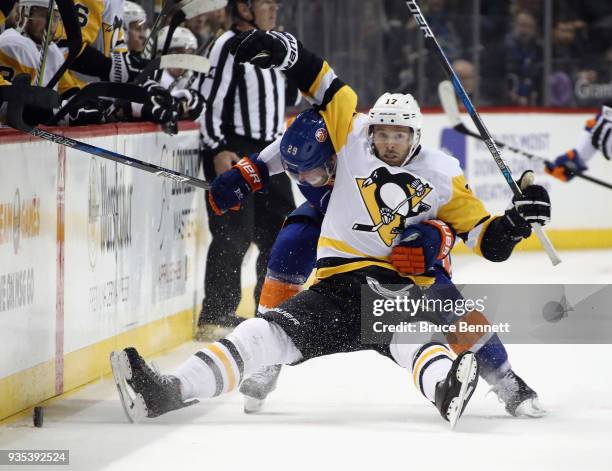 Brock Nelson of the New York Islanders gets under Bryan Rust of the Pittsburgh Penguins during the second period at the Barclays Center on March 20,...