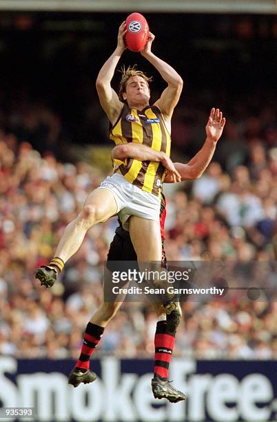 Trent Croad for Hawthorn takes a mark over Steven Alessio for Essendon during the AFL Preliminary Final match played between the Essendon Bombers and...