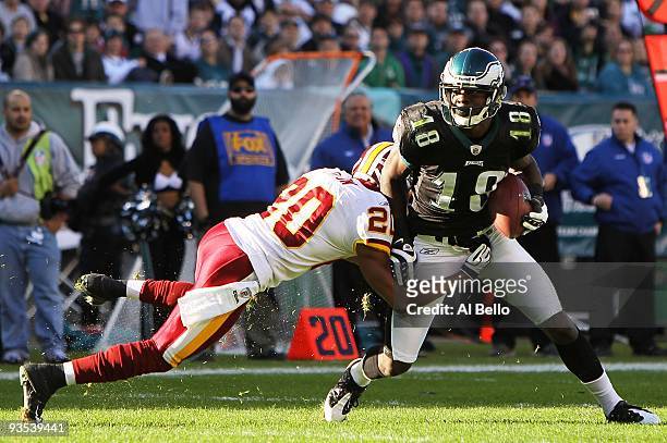 Jeremy Maclin of the Philadelphia Eagles is tackled by Justin Tryon of the Washington Redskins during their game at Lincoln Financial Field on...