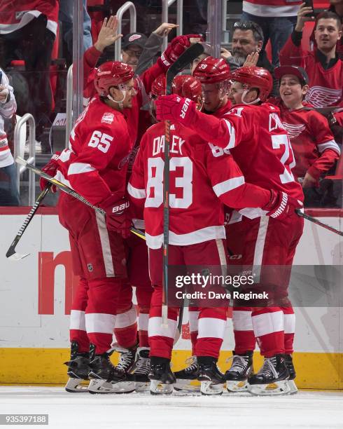 Dylan Larkin of the Detroit Red Wings celebrates his second period goal with teammates Danny DeKeyser, Trevor Daley and Anthony Mantha during an NHL...