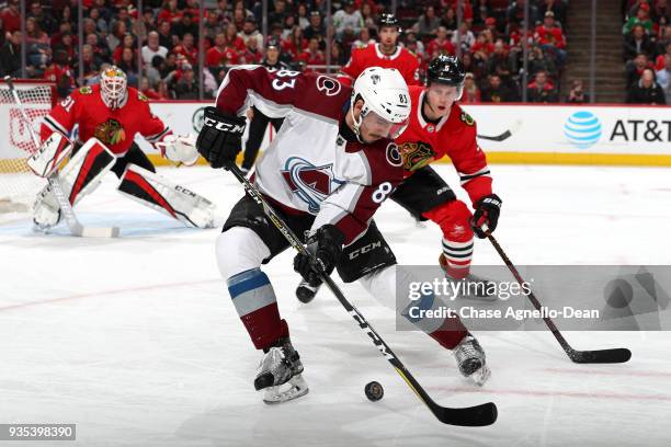 Matt Nieto of the Colorado Avalanche approaches the puck ahead of Connor Murphy of the Chicago Blackhawks in the first period at the United Center on...