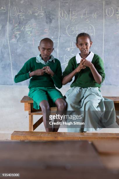 deaf children learning sign language at school. - hugh sitton stock pictures, royalty-free photos & images