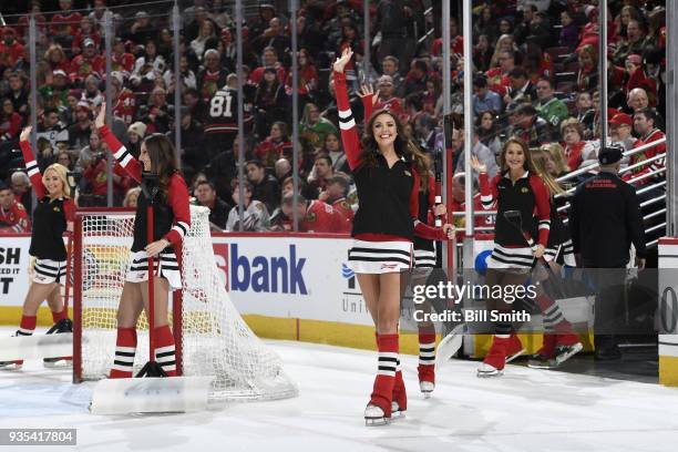 The Chicago Blackhawks ice-crew waves to the crowd during the game between the Chicago Blackhawks and the Colorado Avalanche at the United Center on...