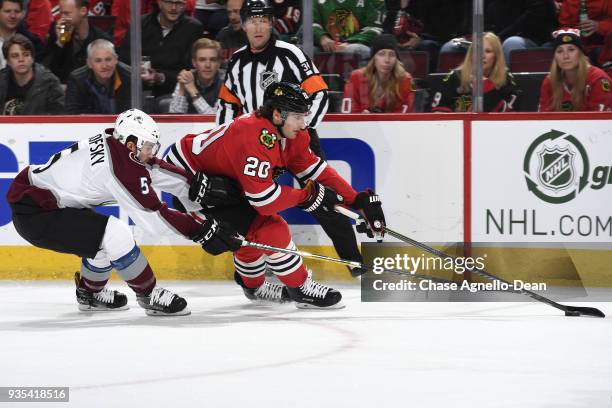 Brandon Saad of the Chicago Blackhawks grabs the puck ahead of David Warsofsky of the Colorado Avalanche in the first period at the United Center on...