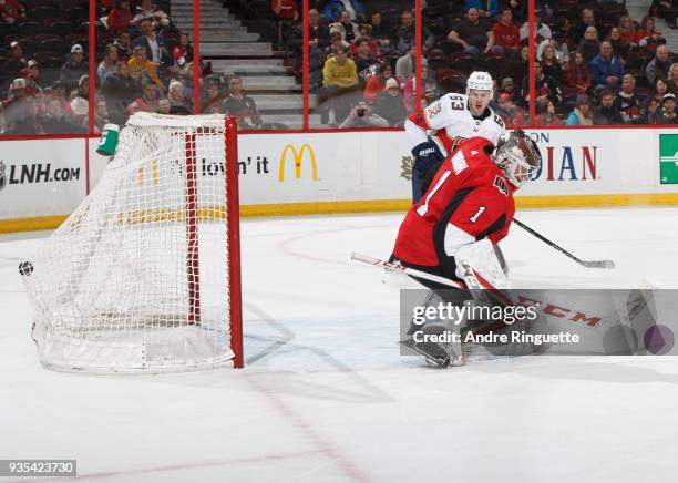 The puck hits the back of the net behind Mike Condon of the Ottawa Senators for a second period goal by Nick Bjugstad as Evgenii Dadonov looks on the...