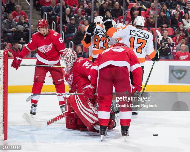 Sean Couturier of the Philadelphia Flyers celebrates his 100th NHL career goal during the second period with teammates Jakub Voracek and Wayne...