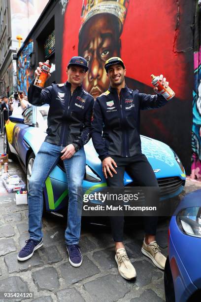 Daniel Ricciardo of Australia and Red Bull Racing and Max Verstappen of Netherlands and Red Bull Racing pose or a photo at an Aston Martin Red Bull...