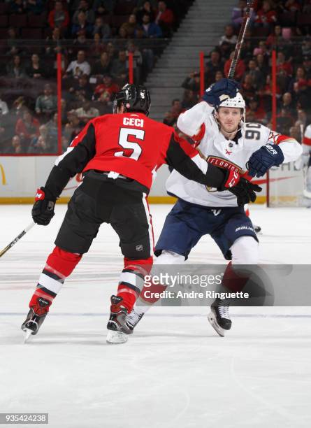 Cody Ceci of the Ottawa Senators slows down Jared McCann of the Florida Panthers as he tries to skate to the puck at Canadian Tire Centre on March...
