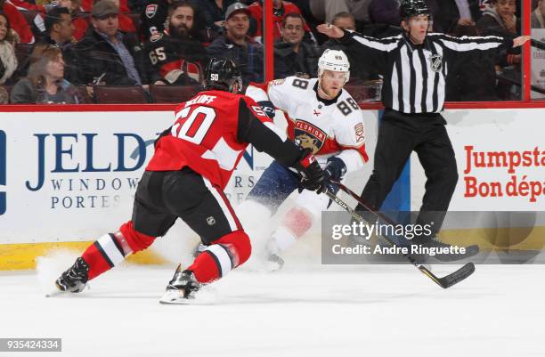 Jamie McGinn of the Florida Panthers stickhandles the puck against Cody Ceci of the Ottawa Senators at Canadian Tire Centre on March 20, 2018 in...