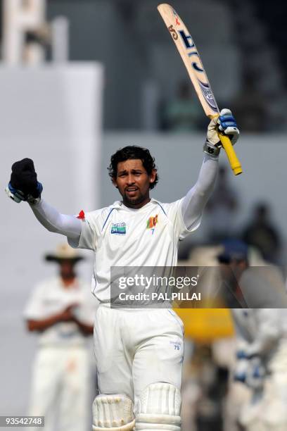 Sri Lankan batsman Tillakaratne Dilshan raises his bat after scoring a century on the first day of the third cricket Test between India and Sri Lanka...