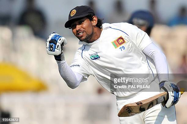 Sri Lankan batsman Tillakaratne Dilshan celebrates after scoring a century on the first day of the third cricket Test between India and Sri Lanka in...