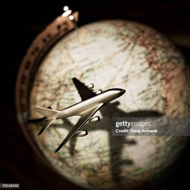 stockillustraties, clipart, cartoons en iconen met model plane circling globe - doug armand