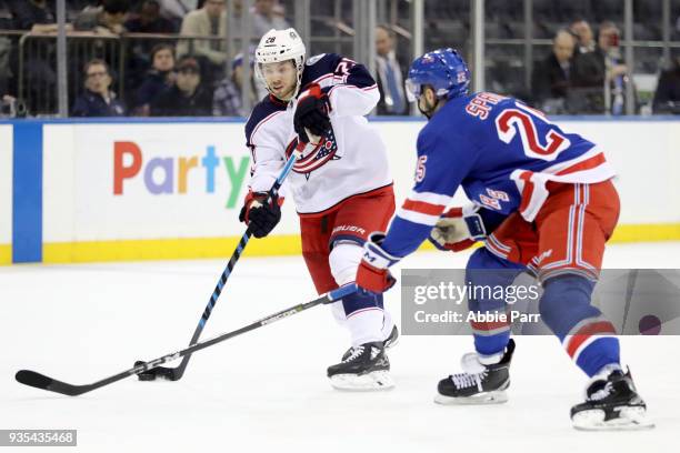 Oliver Bjorkstrand of the Columbus Blue Jackets looks to pass the puck against Ryan Sproul of the New York Rangers in the third period during their...