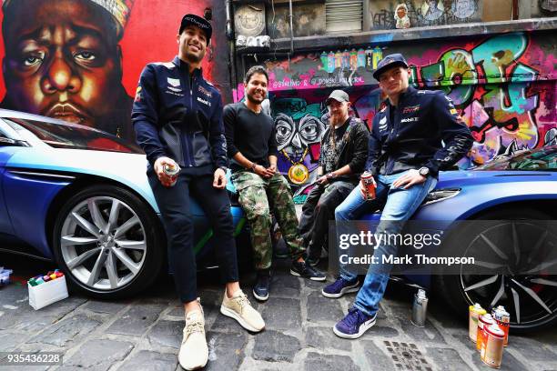 Daniel Ricciardo of Australia and Red Bull Racing and Max Verstappen of Netherlands and Red Bull Racing pose for a photo with street artists Julian...